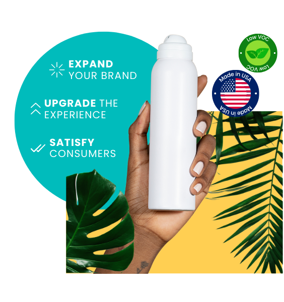 Yellow background with tropical palm leaves and hand holding a white, clean aerosol can. Blue circle background with text, Expand your brand, Upgrade the experience, and Satisfy consumers. Made in USA and Low VOC badges.